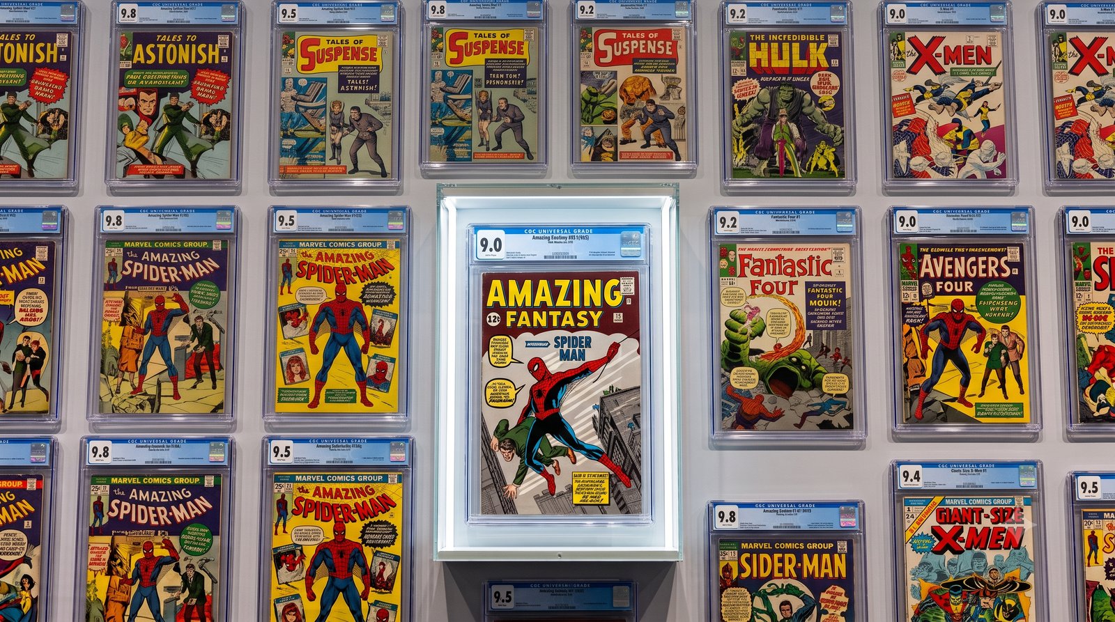 Wall display of CGC graded Silver Age Marvel comics centered on Amazing Fantasy #15 from a consigned collection